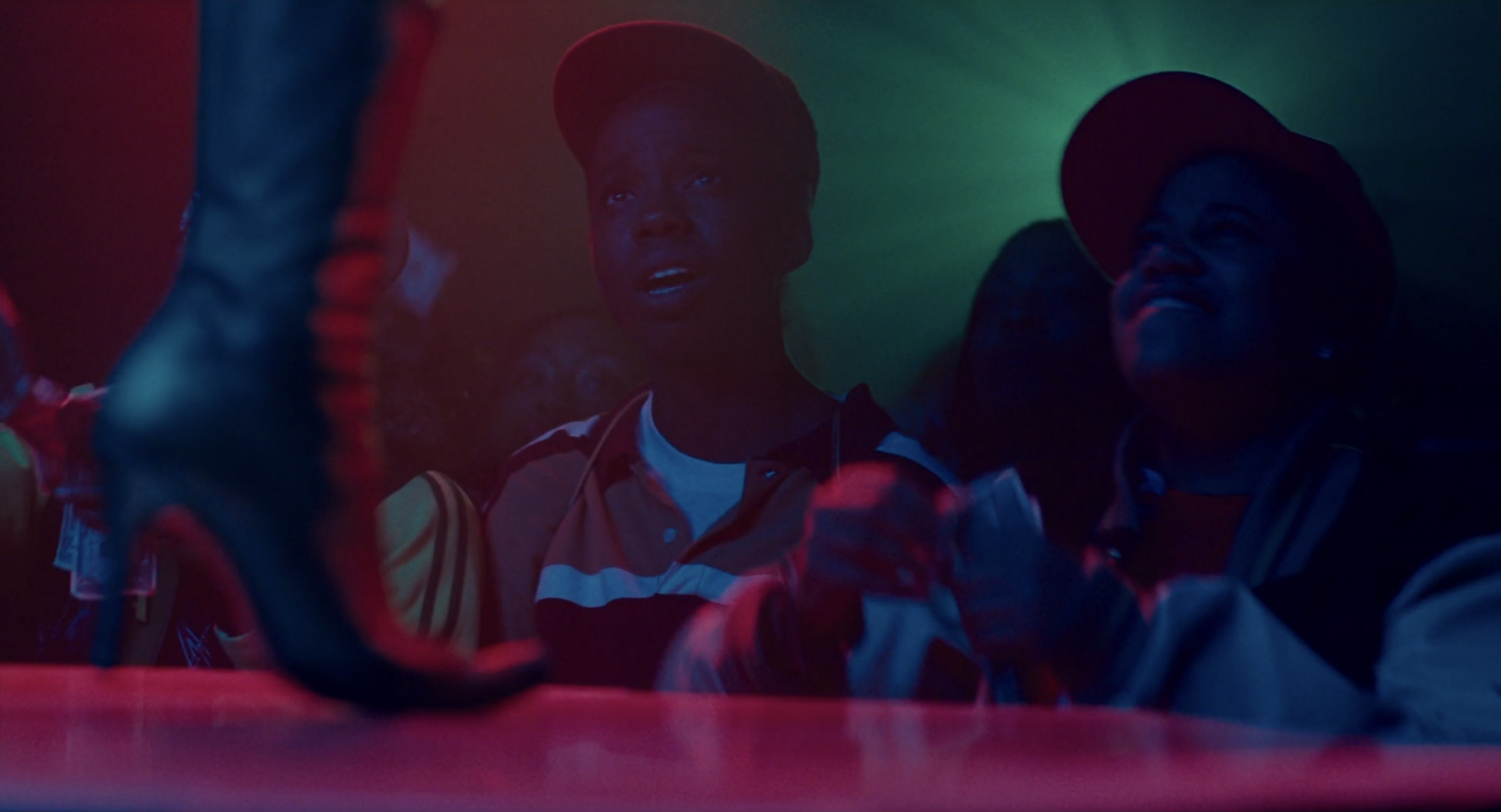 The best lesbian night club scenes: Alike looks up at a dancer on stage in Pariah