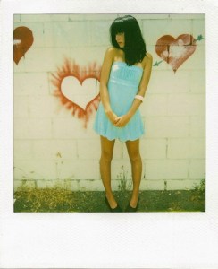 polaroid - girl in front of wall