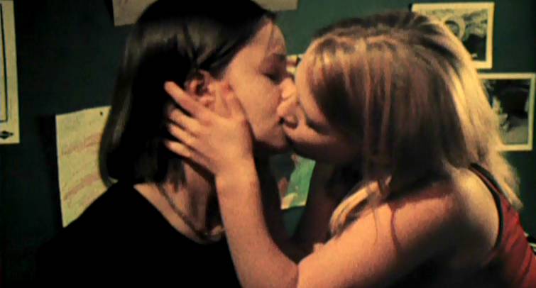 Two teen girls kiss