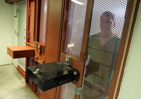 "An inmate looks out from his cell at the Tamms Correctional Center in 2009. The super-max prison in Tamms, Ill., would close under the budget to be unveiled Wednesday by Gov. Pat Quinn. ( Chicago Tribune / February 13, 2009 )