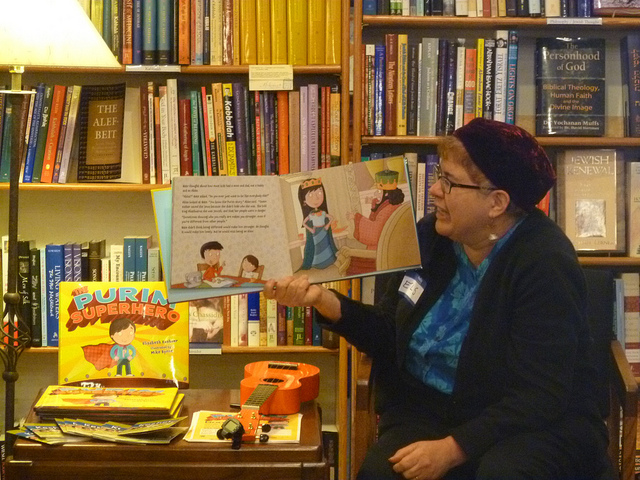 Author Elisabeth Kushner reading her book, The Purim Superhero, at a launch party at Afikomen Judaica in the Bay Area via Keshet