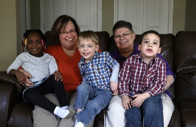 April DeBoer, second from left, sits with her adopted daughter Ryanne, 3, left, and Jayne Rowse, fourth from left, and her adopted sons Jacob, 3, middle, and Nolan, 4, right. Image by Paul Sancya / AP, via Buzzfeed
