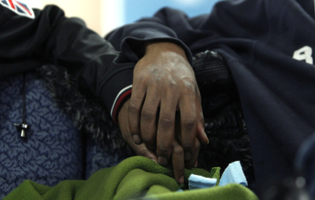 Two boys hold hands at the Ruth Ellis Center in Detroit, the only nonprofit agency in the Midwest that focuses on LGBT youths. It has 10 beds. AP Photo by Paul Sancy, 2012.