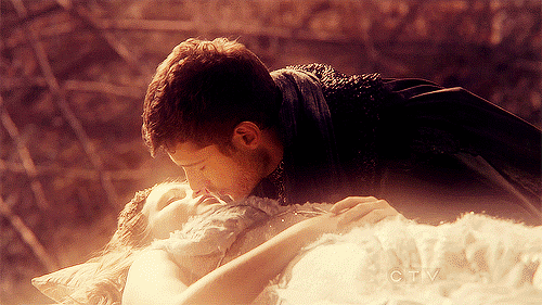 A prince kisses a sleeping princess. Magically, she awakens.