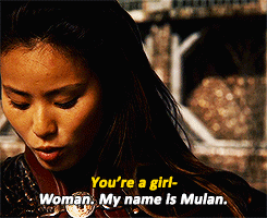 Off screen: "You're a girl-" Asian person on screen: "Woman. My name is Mulan."