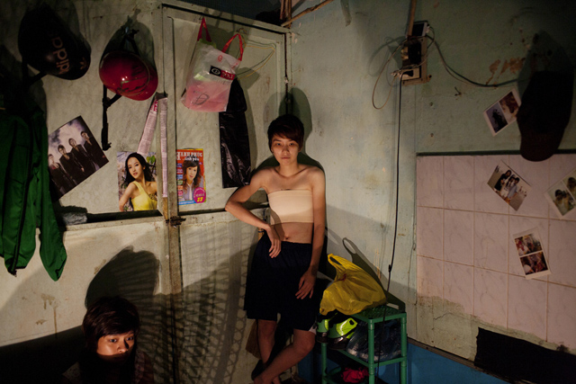 Nguyen Thi Kim Ngan and Dam Ngoc Hoang watch a horror movie in their apartment in Ho Chi Minh City