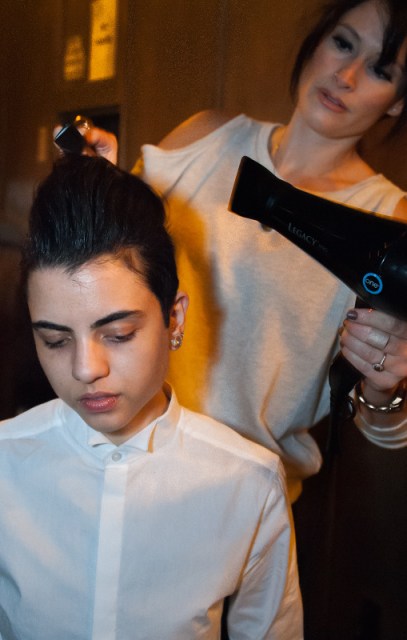 Chris Konnaris' hair is styled backstage. Copyright Joi Ong.