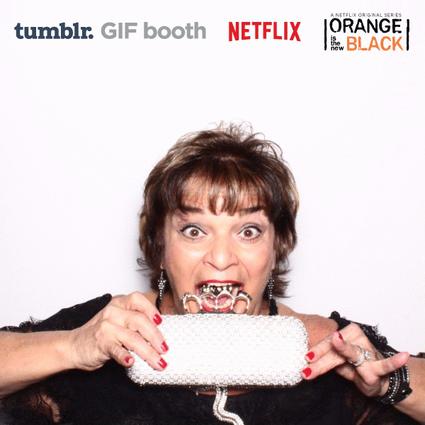 Lin Tucci biting her purse at the OITNB premiere.