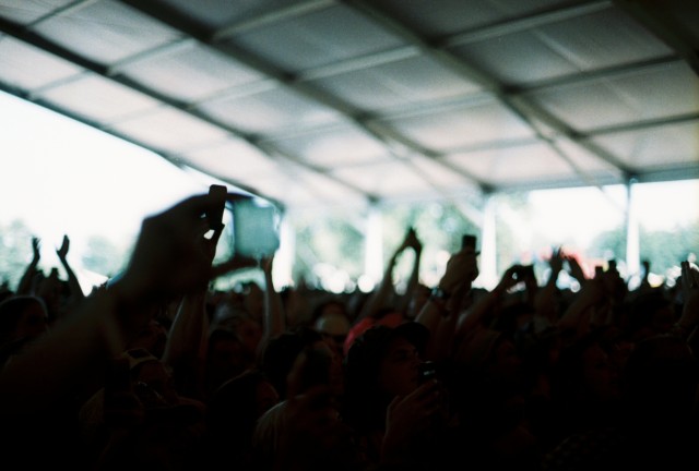 Several humans being excited under a tent.