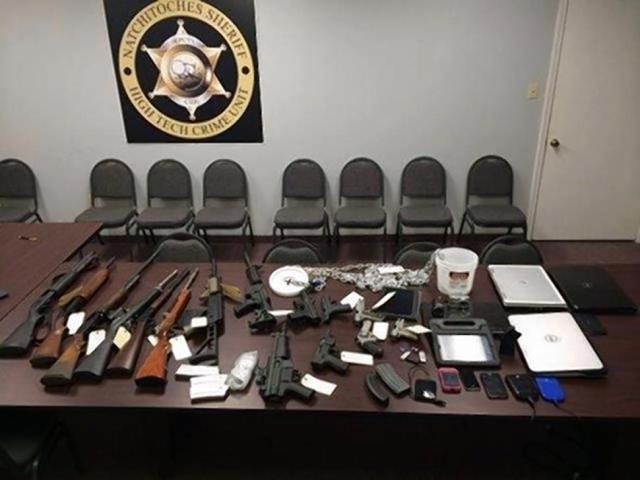 The firearms and computer equipment recovered from the residence.
