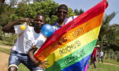 Ugandan men hold a rainbow flag reading