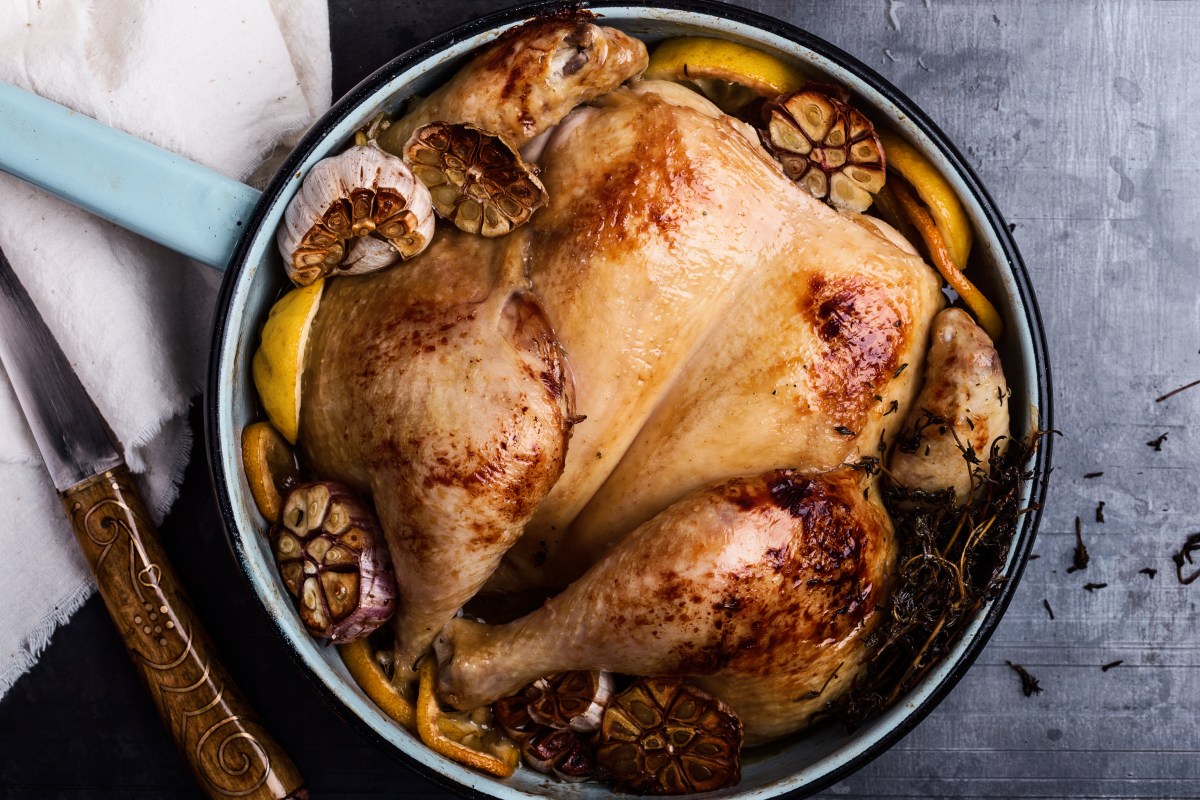 Homemade roasted chicken with spices, thyme and lemon, top view