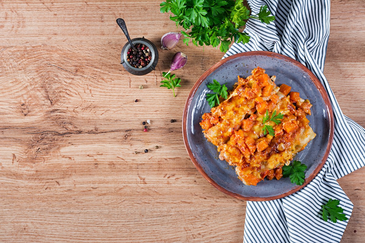 Meat cannelloni pumpkin-tomato sauce on plate. Top view