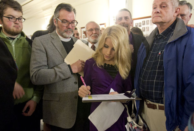 D.W. Trantham signing up to testify. Photo via Katherine Jones, The Idaho Statesman.