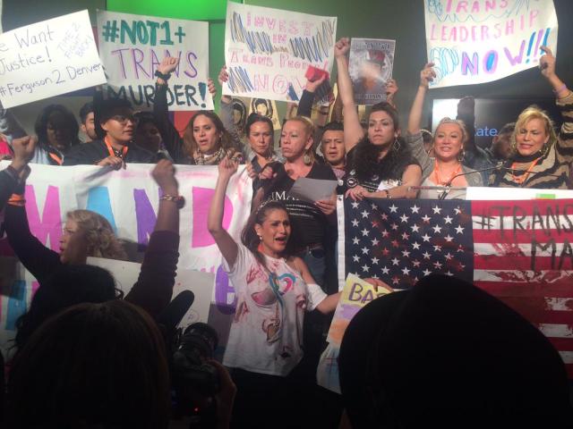Protestors raise fists in solidarity. (image via The National LGBTQ Task Force)