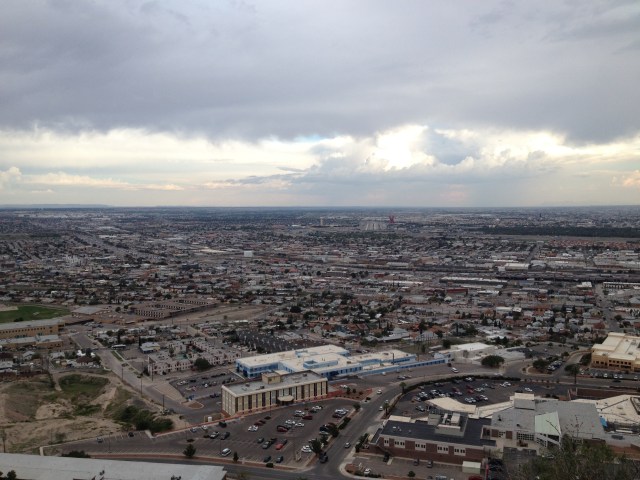 El Paso, TX and Juarez, Chihuahua - Just below the horizon, a little to the right of the center of the photo, you can see a red sculpture, and to the left of that, you can see the US/Mexico Border, plowing its way between the cities.