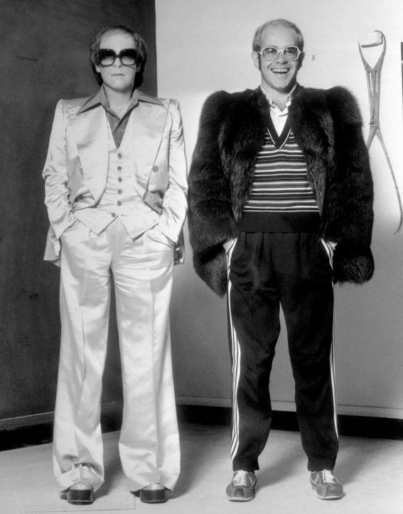 Elton John with his wax figure, 1976, via The Mirror