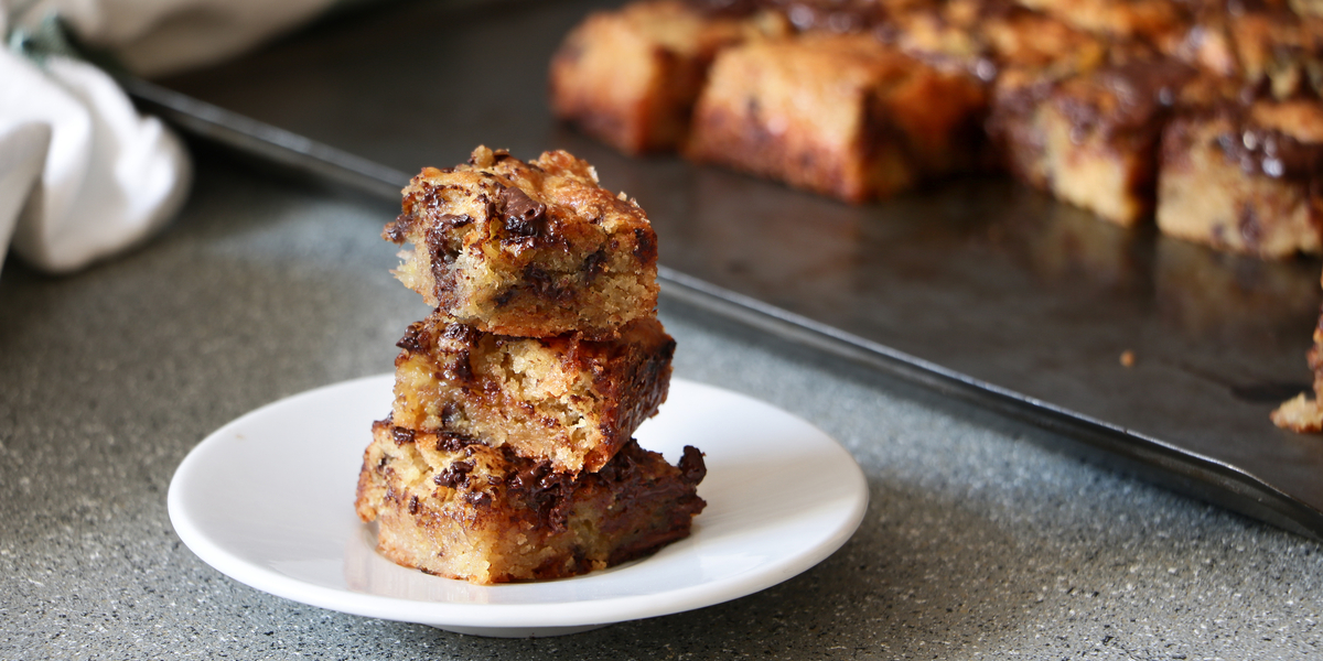 A stack of Blondies next to a tray of edible blondies