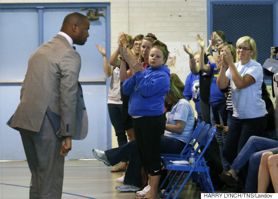 Image #: 36945118    Efland-Cheeks Elementary teacher Omar Currie turns to acknowledge the applause of his fellow teachers and parents after an impassioned speech in front of the school's media review committee in the school gym Friday evening, May 15, 2015 in Efland, N.C. Currie is at the center of a controversy of reading an approved gay-themed fable book to kids in his elementary class. Over two hundred turned out Friday to speak to the review committee on the issue of the controversial book read to children at the school. (Harry Lynch/News & Observer/TNS)       Raleigh News & Observer/ TNS /LANDOV