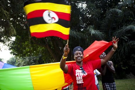 An activist is holding the Ugandan flag during the first Gay Pride in Uganda, which took place at Entebbe beach on August 4, 2012.
