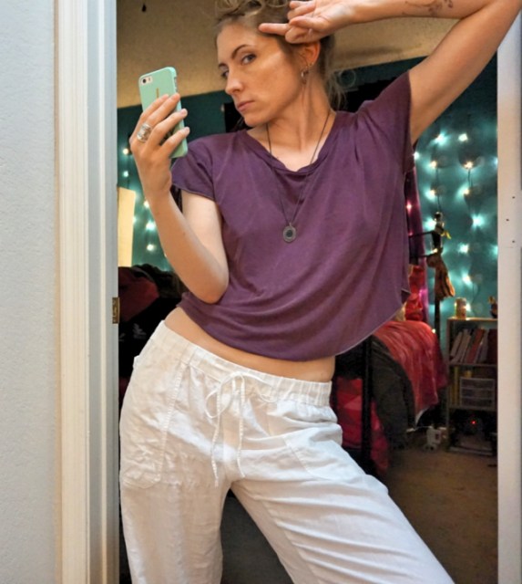 34-year-old executive editor of a very famous online publication and overall cool mom, Laneia, is ready for date night in an aubergine crop top with no bra and hoop earrings.