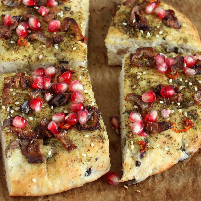 QUINOA OLIVE FOCACCIA CRUST PIZZA WITH ISRAELI ZA’ATAR, CARAMELIZED ONIONS AND POMEGRANATE. VEGAN RECIPE