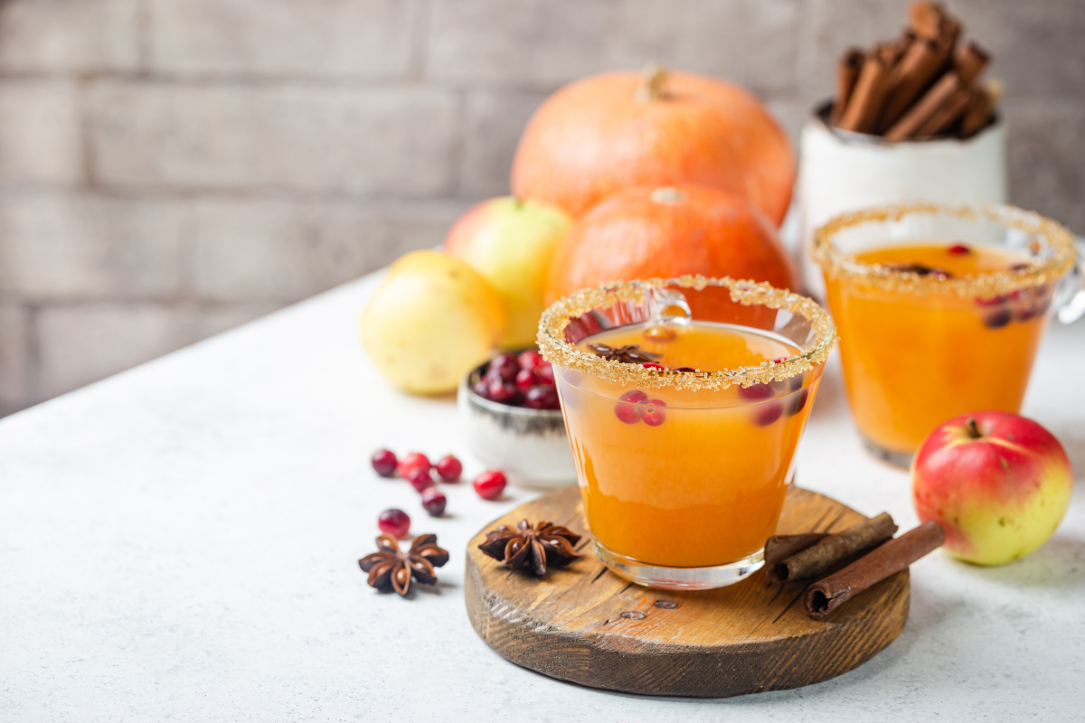 A glass of pumpkin cider on an autumnal table