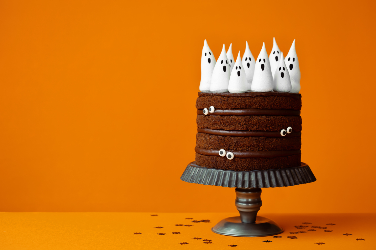 A chocolate layer cake with ghost frosting on top