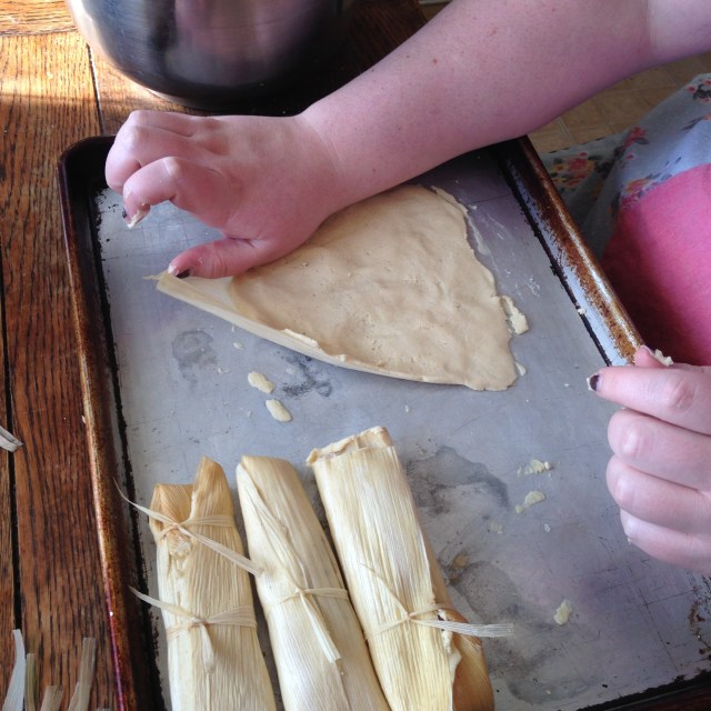 Spreading out the masa.