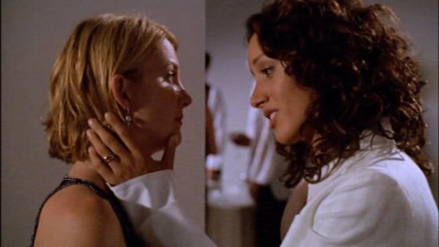 Bette and Tina in "The L Word" looking into each other's eyes sadly