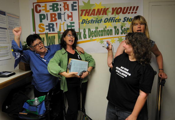 LOS ANGELES, CA - MAY 26: Susan Forrest (R) takes a snapshot of Jeanne Cordova (L) and Lynn Ballen (2L), as Forrest's partner Talia Betther looks on, as they lead a chant for demonstrators outside the East Los Angeles Marriage License Office May 26, 2009 in Los Angeles, California. They were part of a group that tried to obtain a marriage license after a rally, organized by Latino Equality Alliance, protesting the California Supreme Court ruling that upheld Proposition 8. The California Supreme Court upheld Proposition 8, a voter-approved ban on same-sex marriage, but also ruled that the estimated 18,000 gay couples who were marred in the state before the law took effect will stay wed. (Photo by Robert Hanashiro-Pool/Getty Images)