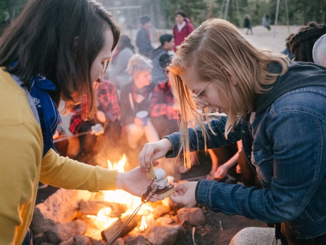 Julia helping Norah make a S'More