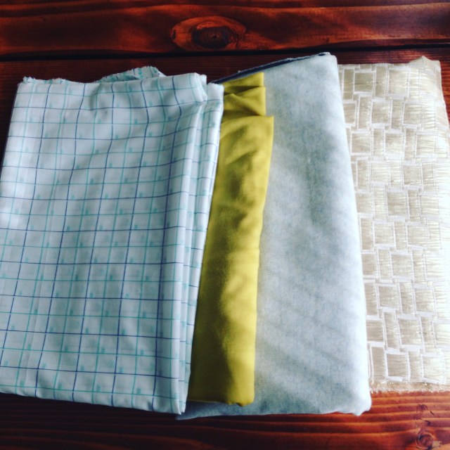 A fabric haul from one of my favorite stores that sources their wool from New Zealand. From left to right, a checkered cotton, a brightly colored knit merino wool, a woven wool blend, and a decorative gold brocade.