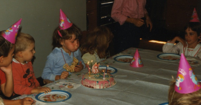 Riese celebrates Autostraddle's 7th birthday with a "6" candle