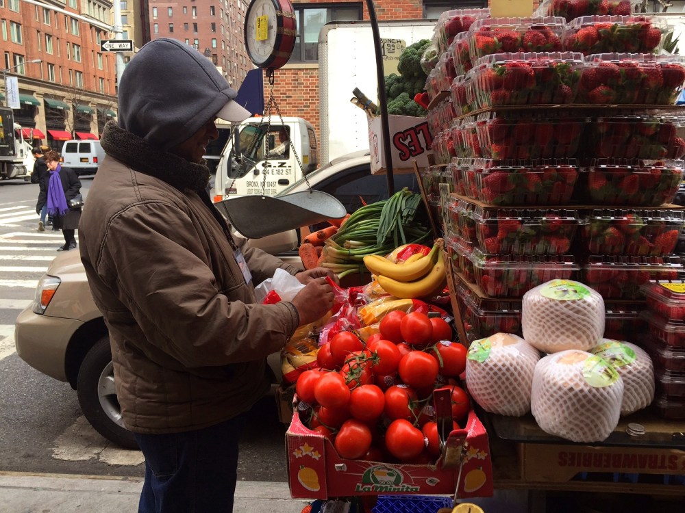 The fruit guy has positioned himself right in front of my job, and I buy fruit for breakfast almost daily. He's smiling because I've just told him I'm photographing him, and he asked me to make him a star. I think he was already a star. 