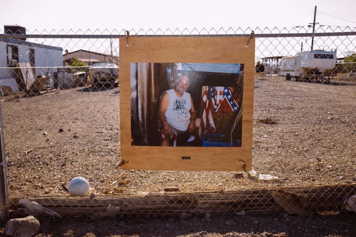 A photographer took and hung photos of the locals outside their properties.