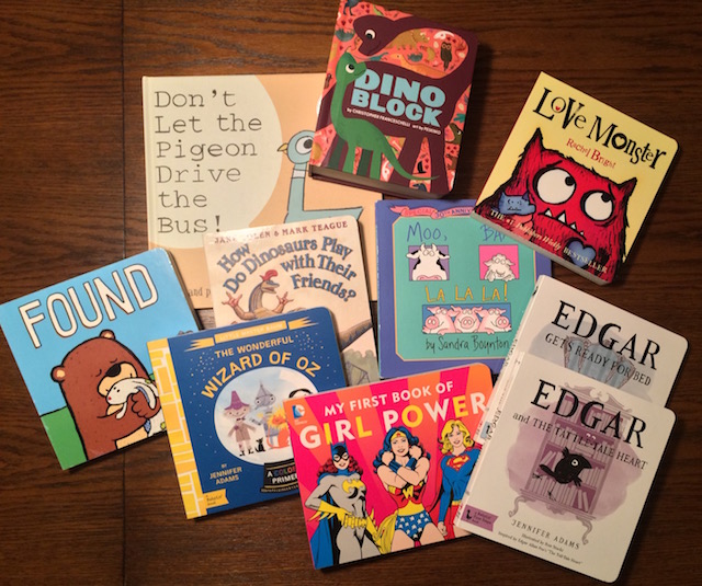 A small sample from Remi's badass baby library: Don't Let the Pigeon Drive the Bus! by Mo Willems, Dino Block by Christopher Franceschelli, Love Monster by Rachel Bright, Found by Salina Yoon, How Do Dinosaurs Play With Their Friends by Jane Yolen, Moo Baa La La La by Sandra Boynton (my childhood favorite), The Wonderful Wizard of Oz: A BabyLit® Colors Primer by Jennifer Adams, My First Book of Girl Power by Julie Merberg, Edgar Gets Ready for Bed: A BabyLit® Board Book: Inspired by Edgar Allan Poe's "The Raven" by Jennifer Adams, and Edgar and the Tattle-tale Heart: A BabyLit® Board Book: Inspired by Edgar Allan Poe's "The Tell-Tale Heart" by Jennifer Adams