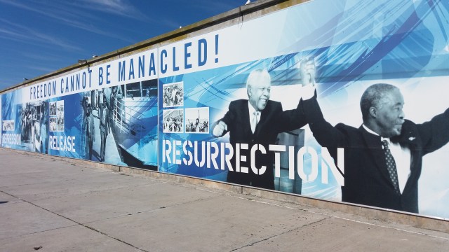 A mural on Robben Island featuring phrases like "Resurrection," "Release," and "Freedom cannot be manacled."