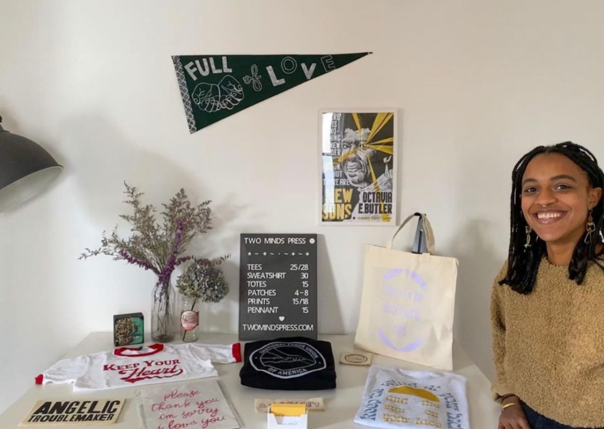Creator at the Feminist Flea with Two Minds Press merch