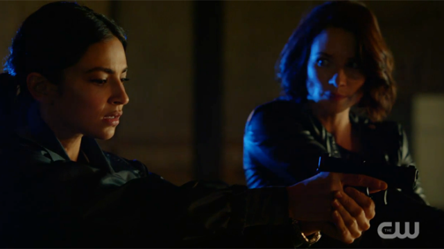 Alex and maggie with guns, Alex looking at Maggie