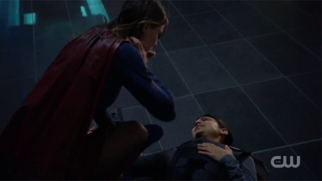 Supergirl checks on an injured Maggie.