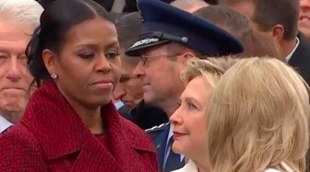 Michelle Obama and Hillary Clinton looking at each other during Trump's inauguration