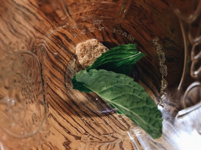 close up of mint leaves and sugar cube in canning jar