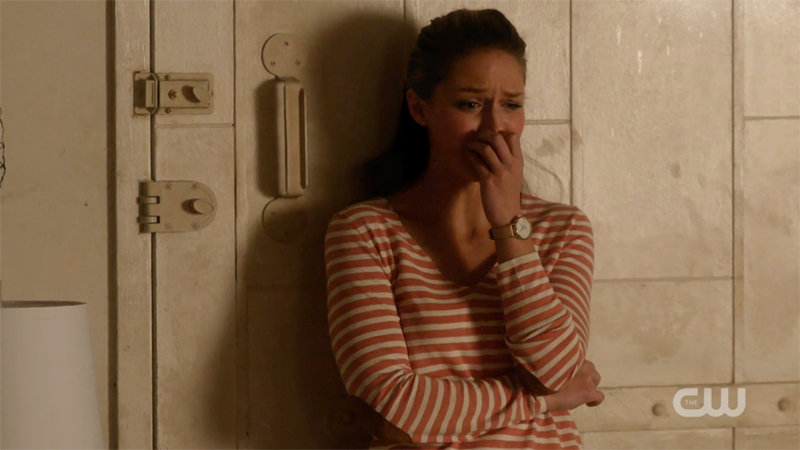 Kara cries, leaning against her door