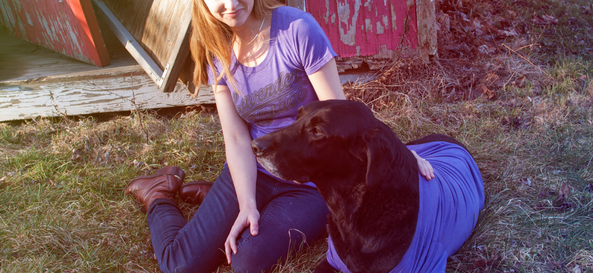 Erin is wearing a small and Cooper is wearing a XL in the women's style Lavender Menace tee.