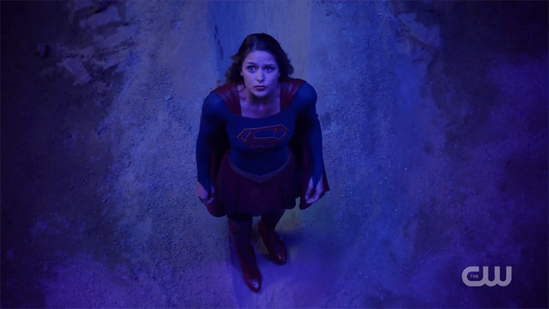 Supergirl looks up at the sky helplessly 