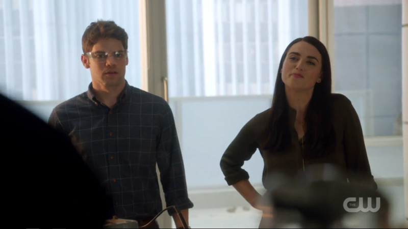 Lena stands with her hand on her hip