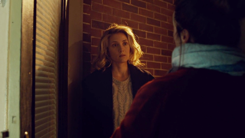 Delphine stands in the doorway, basking in the porchlight like an angel