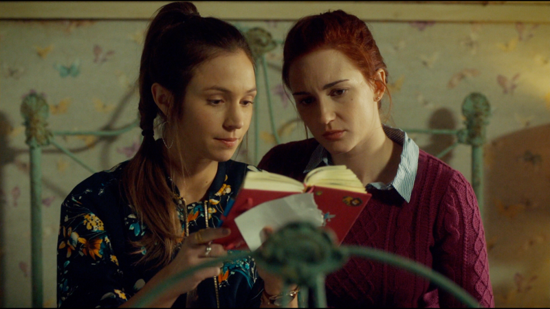 Waverly and Nicole sit on the bed reading Willa's diary and it's VERY CUTE