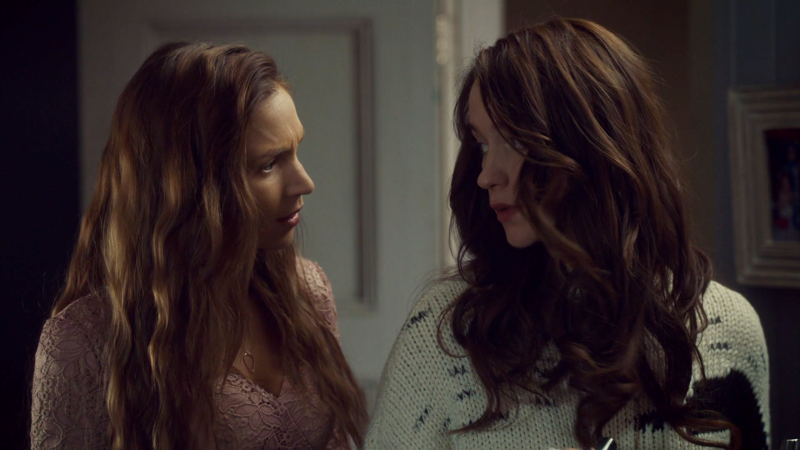 Wynonna and Waverly look at each other after doing a little sister bit 